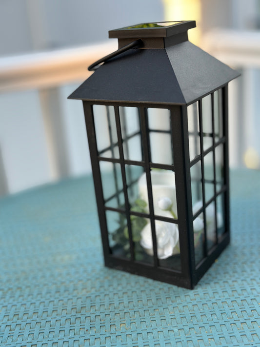 Solar Powered Black Lantern with Faux Candle and White Artificial Flowers