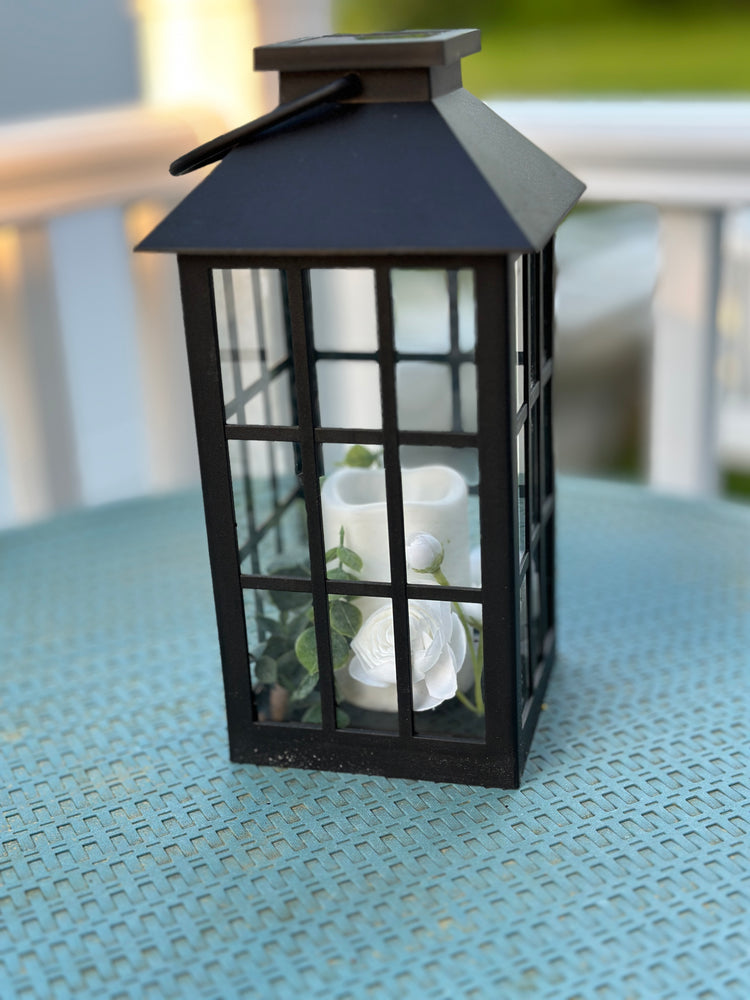 Solar Powered Black Lantern with Faux Candle and White Artificial Flowers